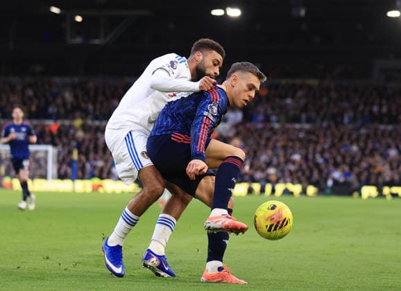 Leeds, England, 31st January 2026. Jayden Bogle of Leeds United (l) tussles with Leandro Trossard of Arsenal (r) during the Leeds United vs Arsenal Premier League match at Elland Road, Leeds. Picture credit should read: Jessica Hornby Sportimage EDITORIAL USE ONLY. No use with unauthorised audio, video, data, fixture lists, club league logos or live services. Online in-match use limited to 120 images, no video emulation. No use in betting, games or single club league player publications. SPI_041_JH_LEEDS_ARSENAL SPI-4494-0045