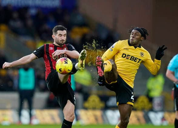 Wolverhampton, England, 31st January 2026. Lewis Cook of Bournemouth competes with Jean-Ricner Bellegarde of Wolverhampton Wanderers during the Wolverhampton Wanderers vs AFC Bournemouth Premier League match at Molineux, Wolverhampton. Picture credit should read: Andrew Yates Sportimage EDITORIAL USE ONLY. No use with unauthorised audio, video, data, fixture lists, club league logos or live services. Online in-match use limited to 120 images, no video emulation. No use in betting, games or single club league player publications. SPI_054_AY_Wolves_Bmouth SPI-4493-0049