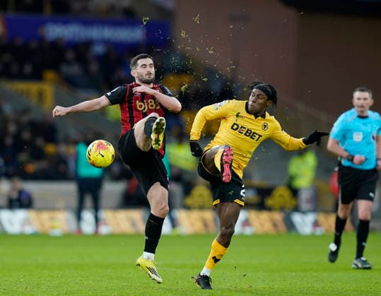 Wolverhampton, England, 31st January 2026. Lewis Cook of Bournemouth competes with Jean-Ricner Bellegarde of Wolverhampton Wanderers during the Wolverhampton Wanderers vs AFC Bournemouth Premier League match at Molineux, Wolverhampton. Picture credit should read: Andrew Yates Sportimage EDITORIAL USE ONLY. No use with unauthorised audio, video, data, fixture lists, club league logos or live services. Online in-match use limited to 120 images, no video emulation. No use in betting, games or single club league player publications. SPI_055_AY_Wolves_Bmouth SPI-4493-0050