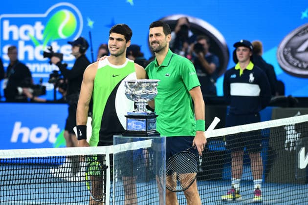 TENNIS AUSTRALIAN OPEN, Carlos Alcaraz of Spain and Novak Djokovic of Serbia pose for photographs at the net during the men™s singles final against Novak Djokovic of Serbia on day 15 of the 2026 Australian Open tennis tournament at Melbourne Park in Melbourne, Sunday, February 1, 2026. ( NO ARCHIVING MELBOURNE VICTORIA AUSTRALIA  Copyright: xJOELxCARRETTx 20260201135989513158
