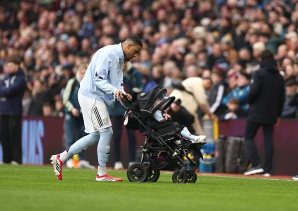 Ezri Konsa of Aston Villa pushes a buggy as he enters the pitch. Aston Villa v Brentford, Premier League, Football, Villa Park, Birmingham, UK - 01 Feb 2026Birmingham Villa Park United Kingdom EDITORIAL USE ONLY No use with unauthorised audio, video, data, fixture lists, club league logos or live services. Online in-match use limited to 120 images, no video emulation. No use in betting, games or single club league player publications. Copyright: xRyanxBrowne Shutterstockx 16496858ag