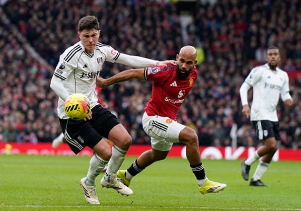 Manchester, England, 1st February 2026. Jorge Cuenca of Fulham (L) challenges Bryan Mbeumo of Manchester United, ManU during the Manchester United vs Fulham Premier League match at Old Trafford, Manchester. Picture credit should read: Andrew Yates Sportimage EDITORIAL USE ONLY. No use with unauthorised audio, video, data, fixture lists, club league logos or live services. Online in-match use limited to 120 images, no video emulation. No use in betting, games or single club league player publications. SPI_030_AY_MAN_UTD_FULHAM SPI-4502-0029