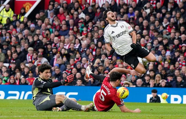 Manchester, England, 1st February 2026. Raul Jimenez of Fulham (up) is fouled for a penalty during the Manchester United, ManU vs Fulham Premier League match at Old Trafford, Manchester. Picture credit should read: Andrew Yates Sportimage EDITORIAL USE ONLY. No use with unauthorised audio, video, data, fixture lists, club league logos or live services. Online in-match use limited to 120 images, no video emulation. No use in betting, games or single club league player publications. SPI_035_AY_MAN_UTD_FULHAM SPI-4502-0034