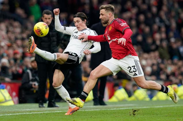 Manchester, England, 1st February 2026. Harry Wilson of Fulham (L) is challenged by Luke Shaw of Manchester United, ManU during the Manchester United vs Fulham Premier League match at Old Trafford, Manchester. Picture credit should read: Andrew Yates Sportimage EDITORIAL USE ONLY. No use with unauthorised audio, video, data, fixture lists, club league logos or live services. Online in-match use limited to 120 images, no video emulation. No use in betting, games or single club league player publications. SPI_052_AY_MAN_UTD_FULHAM SPI-4502-0051