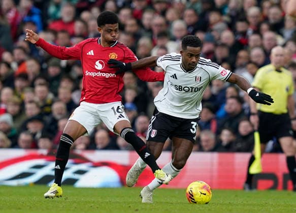 Manchester, England, 1st February 2026. Ryan Sessegnon of Fulham (R) is challenged by Amad Diallo of Manchester United, ManU during the Manchester United vs Fulham Premier League match at Old Trafford, Manchester. Picture credit should read: Andrew Yates Sportimage EDITORIAL USE ONLY. No use with unauthorised audio, video, data, fixture lists, club league logos or live services. Online in-match use limited to 120 images, no video emulation. No use in betting, games or single club league player publications. SPI_057_AY_MAN_UTD_FULHAM SPI-4502-0056
