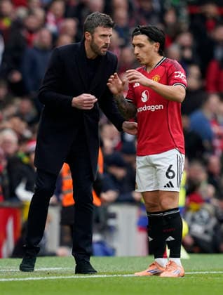 Manchester, England, 1st February 2026. Michael Carrick manager of Manchester United, ManU (L) talks to Lisandro Martinez of Manchester United during the Manchester United vs Fulham Premier League match at Old Trafford, Manchester. Picture credit should read: Andrew Yates Sportimage EDITORIAL USE ONLY. No use with unauthorised audio, video, data, fixture lists, club league logos or live services. Online in-match use limited to 120 images, no video emulation. No use in betting, games or single club league player publications. SPI_062_AY_MAN_UTD_FULHAM SPI-4502-0061