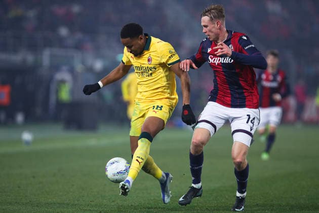 Christopher Nkunku of AC Milan and Torbjorn Heggem of Bologna FC compete for the ball during the serie A match between Bologna FC and AC Milan at Renato dall™Ara stadium in Bologna (Italy), February 3, 2026. massimilianoxcarnabuci