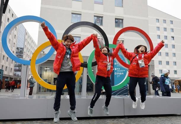 Milan Cortina Winter Olympics Japanese figure skater Kaori Sakamoto (R) and Figure skating, Eiskunstlauf pair Utana Yoshida (C) and Masaya Morita jump in front of Olympics rings at the athletes village for the Milan Cortina Olympics in Milan on Feb. 3, 2026, ahead of the games opening on Feb. 6.  A14AA0005243397P