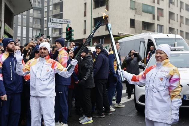 Milan Cortina Olympics: Torch relay Torch relay runners transfer the Olympic flame in Milan on Feb. 5, 2026, ahead of the upcoming Milan Cortina Olympics.  A14AA0005246518P