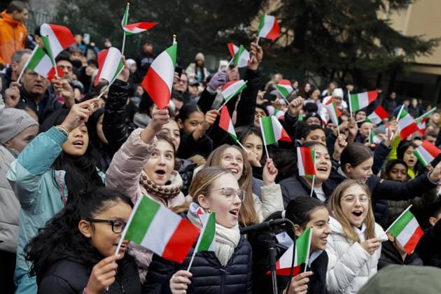 Milan Cortina Olympics: Torch relay Children wave Italian flags during the Milan Cortina Olympics torch relay in Milan on Feb. 5, 2026.  A14AA0005246579P