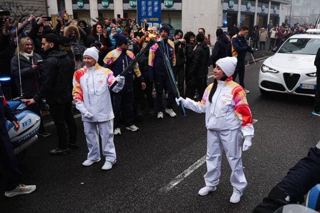 Winter Olympics - Olympic Flame Journey For Milan Cortina 2026 - Sesto San Giovanni Sesto San Giovanni, The journey of the Olympic Flame of the XXV Winter Olympic Games, Olympische Spiele, Olympia, OS Milan Cortina 2026. In the photo: The passage of a torchbearer with the Olympic Torch Photo by Alessandro Bremec IPA ABACAPRESS.COM Cortina d Ampezzo Italy  Copyright: xIPA ABACAx