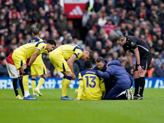 Manchester, England, 7th February 2026. Destiny Udogie of Tottenham receives treatment before leaving the game injured during the Manchester United, ManU vs Tottenham Hotspur Premier League match at Old Trafford, Manchester. Picture credit should read: Andrew Yates Sportimage EDITORIAL USE ONLY. No use with unauthorised audio, video, data, fixture lists, club league logos or live services. Online in-match use limited to 120 images, no video emulation. No use in betting, games or single club league player publications. SPI_075_AY_Man_Utd_Spurs SPI-4511-0075