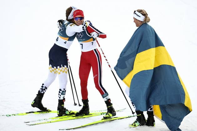 ITALY, TRENTINO-SOUTH TYROL - FEBRUARY 7, 2026: Ebba Andersson of Sweden, Heidi Weng of Norway, and Frida Karlsson (L-R) of Sweden celebrate coming second, third and first respectively in a women s 10km + 10km skiathlon race during the 2026 Winter Olympic Games, Olympische Spiele, Olympia, OS at the Tesero Cross-Country Skiing Stadium 2026 Winter Olympics: Cross-Country Skiing  - ZUMAt113 20260207_zaa_t113_215 Copyright: xMikhailxTereshchenkox