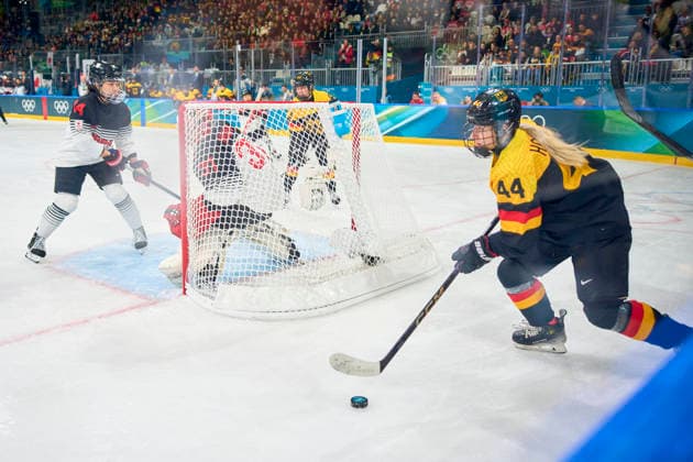 Hanna Hoppe of Germany compete and fight for the puck against Riko Kawaguchi of Japan at the preliminary women Ice hockey, Eishockey match Group B Germany-Japan of the Milano Cortina 2026 Winter Olympic Games, Olympische Spiele, Olympia, OS at Milano Rho Ice Hockey Arena on February 7, 2026 in Milan, Italy.