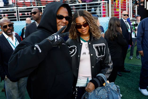 Singer-songwriter Beyonce, right, and Jay Z, left, pose on the field before the start of Super Bowl LX at at Levi s Stadium in Santa Clara, California on Sunday, February 8, 2026.  SBP20260208117 JOHNxANGELILLO