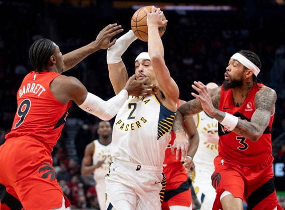 February 8, 2026, Toronto, On, Canada: Indiana Pacers guard Andrew Nembhard (2) is double teamed by Toronto Raptors Brandon Ingram (3) and R.J. Barrett (9) as he drives to the hoop during first half NBA, Basketball Herren, USA action in Toronto on Sunday Feb. 8, 2026. Canada News - February 8, 2026  - ZUMAc35_ 20260208_zaf_c35_171 Copyright: xFrankxGunnx