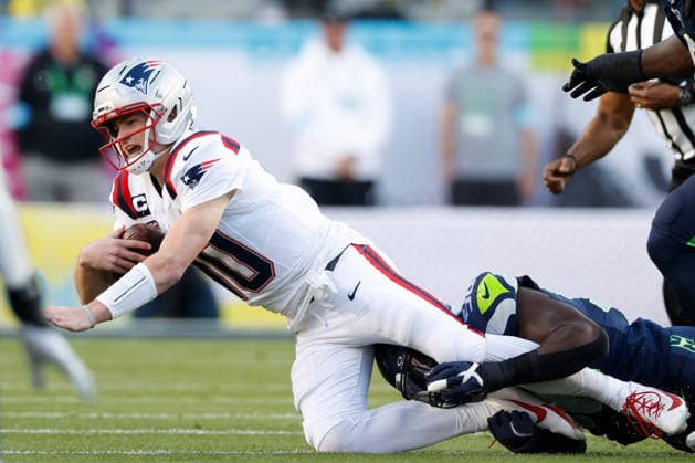 New England Patriots quarterback Drake Maye left, is sacked by Seattle Seahawks linebacker Derick Hall right, during the first quarter of Super Bowl LX at at Levi s Stadium in Santa Clara, California on Sunday, February 8, 2026.  SBP20260208137 JOHNxANGELILLO