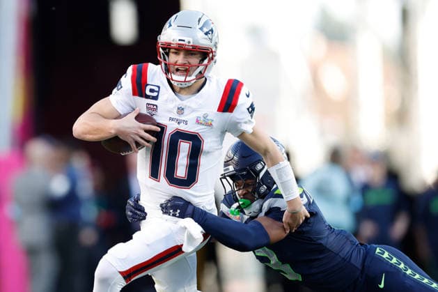 New England Patriots quarterback Drake Maye runs with the ball as Seattle Seahawks safety Nick Emmanwori reaches for the tackle during the first quarter of Super Bowl LX at at Levi s Stadium in Santa Clara, California on Sunday, February 8, 2026.  SBP20260208138 JOHNxANGELILLO