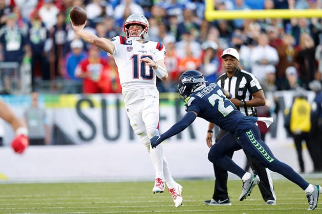 New England Patriots quarterback Drake Maye left, makes a throw as Seattle Seahawks cornerback Devon Witherspoon rushes during the first quarter of Super Bowl LX at at Levi s Stadium in Santa Clara, California on Sunday, February 8, 2026.  SBP20260208139 JOHNxANGELILLO