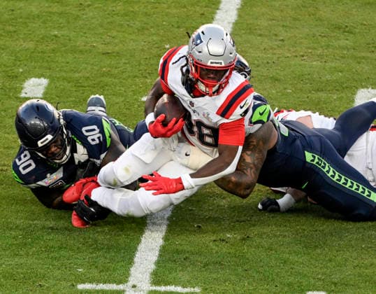 New England Patriots running back Rhamondre Stevenson (38) is tackled by Seattle Seahawks defensive tackle Jarran Reed (90) and Seattle Seahawks defensive end Leonard Williams (99) in the second quarter of Super Bowl LX at at Levi s Stadium in Santa Clara, California on Sunday, February 8, 2026.  SBP20260208825 JONxSOOHOO