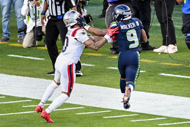 Seattle Seahawks running back Kenneth Walker III (9) is pushed out of bounds by New England Patriots cornerback Christian Gonzalez (0) after a first down in the second quarter of Super Bowl LX at Levi s Stadium in Santa Clara, California on Sunday, February 8, 2026.  SBP20260208444 DAVIDxTULIS
