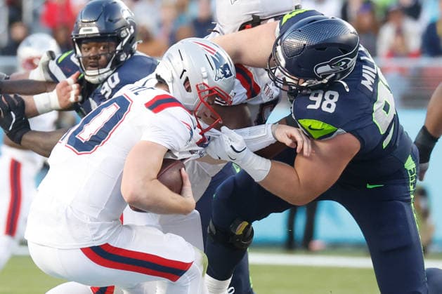 Seattle Seahawks defensive tackle Rylie Mills right, sacks New England Patriots quarterback Drake Maye left, during the second quarter of Super Bowl LX at Levi s Stadium in Santa Clara, California on Sunday, February 8, 2026.  SBP20260208146 JOHNxANGELILLO