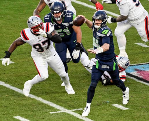 Seattle Seahawks quarterback Sam Darnold (14) passes under pressure from New England Patriots defensive end Milton Williams (97) in the second quarter of Super Bowl LX at at Levi s Stadium in Santa Clara, California on Sunday, February 8, 2026.  SBP20260208830 JONxSOOHOO