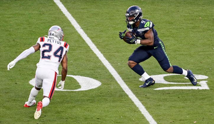Seattle Seahawks running back Kenneth Walker III (9) runs for a first down against New England Patriots safety Dell Pettus (24) in the second quarter of Super Bowl LX at at Levi s Stadium in Santa Clara, California on Sunday, February 8, 2026.  SBP20260208832 JONxSOOHOO