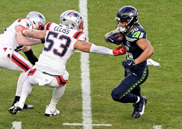New England Patriots linebacker Christian Elliss (53) reaches for Seattle Seahawks running back George Holani (36) on a run in the second quarter of Super Bowl LX at at Levi s Stadium in Santa Clara, California on Sunday, February 8, 2026.  SBP20260208836 JONxSOOHOO