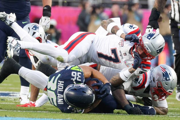 Seattle Seahawks running back George Holani, left, is taken down by New England Patriots cornerback Carlton Davis III right, during the second quarter of Super Bowl LX at Levi s Stadium in Santa Clara, California on Sunday, February 8, 2026.  SBP20260208150 JOHNxANGELILLO