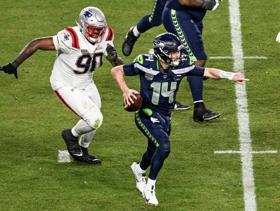 Seattle Seahawks quarterback Sam Darnold (14) directs his team as New England Patriots defensive tackle Christian Barmore (90) pursues in the third quarter of Super Bowl LX at at Levi s Stadium in Santa Clara, California on Sunday, February 8, 2026.  SBP20260208851 JONxSOOHOO