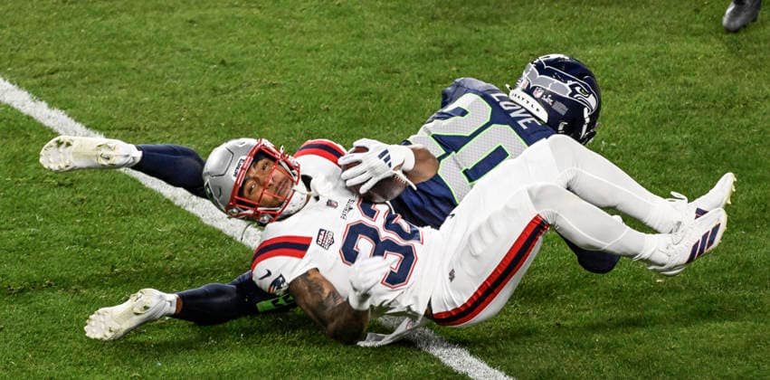 New England Patriots running back Treveyon Henderson (32) runs the ball on Seattle Seahawks safety Julian Love (20) in the third quarter of Super Bowl LX at at Levi s Stadium in Santa Clara, California on Sunday, February 8, 2026.  SBP20260208853 JONxSOOHOO