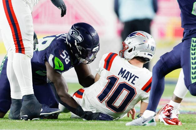 New England Patriots quarterback Drake Maye, right, is sacked by Seattle Seahawks linebacker Derick Hall left, during the third quarter of Super Bowl LX at Levi s Stadium in Santa Clara, California on Sunday, February 8, 2026.  SBP20260208181 JOHNxANGELILLO
