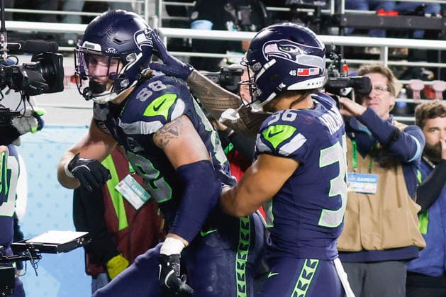 Seattle Seahawks tight end AJ Barner left, is congratulated by teammate Seattle Seahawks running back George Holani right, after Barner scored a touchdown during the third quarter of Super Bowl LX against the New England Patriots at Levi s Stadium in Santa Clara, California on Sunday, February 8, 2026.  SBP20260208185 JOHNxANGELILLO