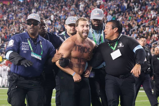 Security detains a fan that ran on the field during the fourth quarter of Super Bowl LX between the New England Patriots and the Seattle Seahawks at Levi s Stadium in Santa Clara, California on Sunday, February 8, 2026.  SBP20260208189 JOHNxANGELILLO