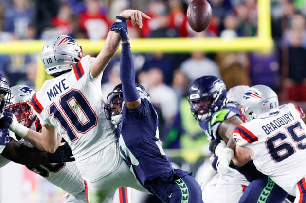 Seattle Seahawks cornerback Devon Witherspoon right, knocks the ball away from New England Patriots quarterback Drake Maye left, during the fourth quarter of Super Bowl LX at Levi s Stadium in Santa Clara, California on Sunday, February 8, 2026.  SBP20260208208 JOHNxANGELILLO