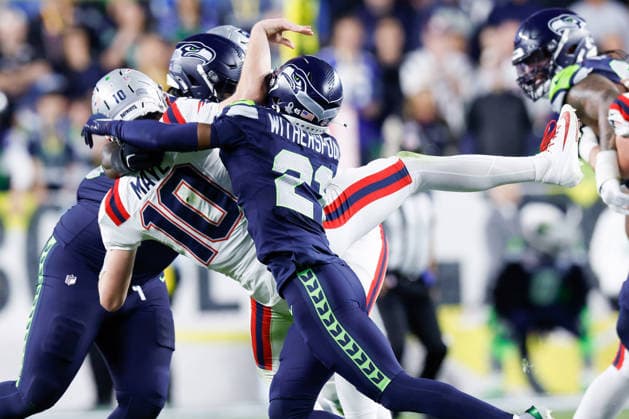 Seattle Seahawks cornerback Devon Witherspoon right, tackles New England Patriots quarterback Drake Maye left, during the fourth quarter of Super Bowl LX at Levi s Stadium in Santa Clara, California on Sunday, February 8, 2026.  SBP20260208209 JOHNxANGELILLO