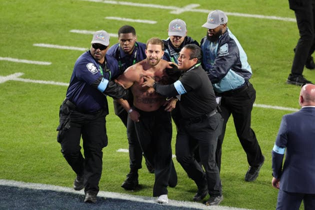 SANTA CLARA, CA - FEBRUARY 08: A fans gets escorted off the field during the Seattle Seahawks versus the New England Patriots Super Bowl LX game on February 8, 2026, at Levi s Stadium in Santa Clara, CA. (Photo by Jevone Moore Icon Sportswire) NFL, American Football Herren, USA FEB 08 Super Bowl LX Seahawks vs Patriots EDITORIAL USE ONLY Icon2602083171