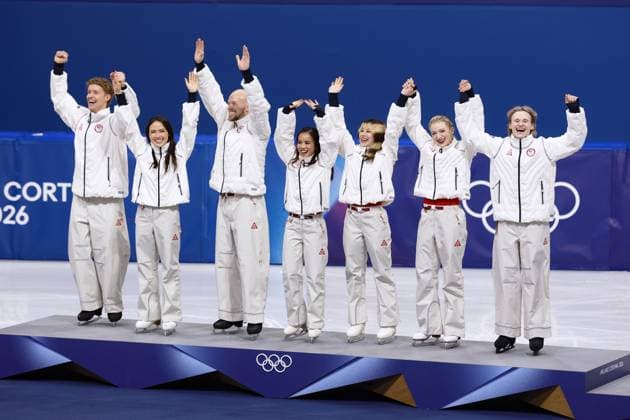 Milan Cortina Olympics: Figure skating, Eiskunstlauf Members of the U.S. figure skating team celebrate on the podium after winning the team event gold at the Milan Cortina Olympics at Milano Ice Skating Arena in Milan on Feb. 8, 2026.  A14AA0005258925P