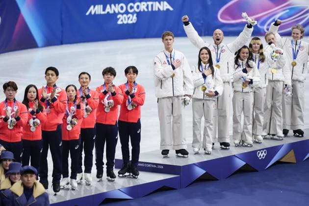 Milan Cortina Olympics: Figure skating, Eiskunstlauf Members of the U.S. figure skating team (R) celebrate on the podium after winning the team event gold at the Milan Cortina Olympics at Milano Ice Skating Arena in Milan on Feb. 8, 2026. Seen on the left is Japan s team, which won silver.  A14AA0005258926P