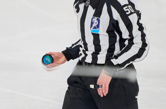 Referee with puck at the preliminary women Ice hockey, Eishockey match Group B Germany - France of the Milano Cortina 2026 Winter Olympic Games, Olympische Spiele, Olympia, OS at Milano Rho Ice Hockey Arena on February 9, 2026 in Milan, Italy.