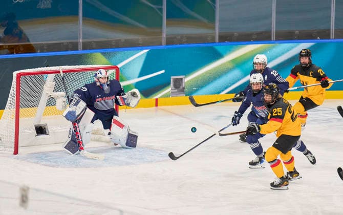 Laura Kluge of Germany compete and fight for the puck against Estelle Duvin of France Lea Villot of France Alice Philbert of France at the preliminary women Ice hockey, Eishockey match Group B Germany - France of the Milano Cortina 2026 Winter Olympic Games, Olympische Spiele, Olympia, OS at Milano Rho Ice Hockey Arena on February 9, 2026 in Milan, Italy.