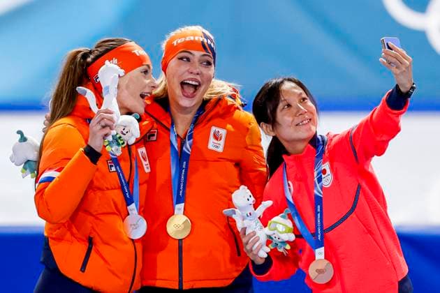 second Femke Kok of the Netherlands and winner Jutta Leerdam of the Netherlands and third Miho Takagi of Japan smiling during the medal ceremony after Women 1000m, Milano Cortina 2026 Winter Olympics: Day 3, Speed skating, Eisschnelllauf - Milano Cortina 2026 Winter Olympics: Day 3, Milano Speed Skating Stadium, February 9, 2026, Milan, Italy.