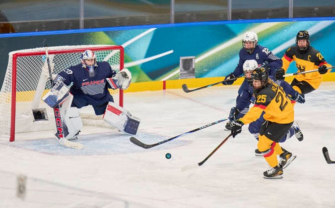 Laura Kluge of Germany compete and fight for the puck against Estelle Duvin of France Lea Villot of France Alice Philbert of France at the preliminary women Ice hockey, Eishockey match Group B Germany - France of the Milano Cortina 2026 Winter Olympic Games, Olympische Spiele, Olympia, OS at Milano Rho Ice Hockey Arena on February 9, 2026 in Milan, Italy.