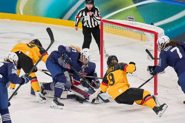 Svenja Voigt of Germany compete and fight for the puck against Elina Zilliox of France Lucie Quarto of France Alice Philbert of France at the preliminary women Ice hockey, Eishockey match Group B Germany - France of the Milano Cortina 2026 Winter Olympic Games, Olympische Spiele, Olympia, OS at Milano Rho Ice Hockey Arena on February 9, 2026 in Milan, Italy.