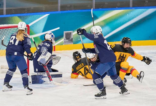 Jule Schiefer of Germany shoulder injury compete and fight for the puck against Lucie Quarto of France at the preliminary women Ice hockey, Eishockey match Group B Germany - France of the Milano Cortina 2026 Winter Olympic Games, Olympische Spiele, Olympia, OS at Milano Rho Ice Hockey Arena on February 9, 2026 in Milan, Italy.