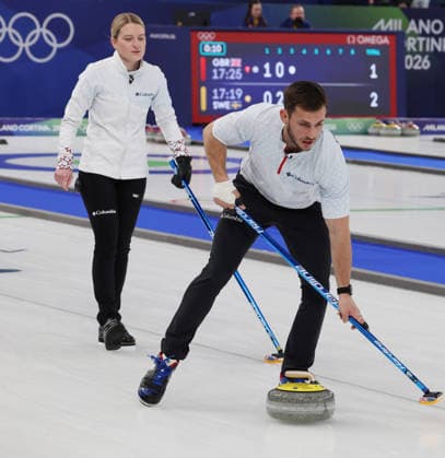 Team USA s Korey Dropkin polishes the ice watched by teammate Corey Thiesse in the Curling Mixed Doubles Semi-Finals against Italy at the 2026 Winter Olympics in Cortina, Italy on Monday February 09, 2026. Team USA beat Italy 9-8.  OLY2026020691 HUGOxPHILPOTT