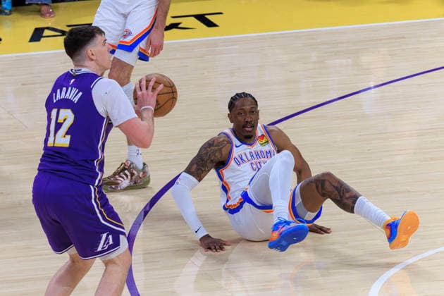 February 9, 2026, Los Angeles, California, USA: Jake LaRavia 12 of the Los Angeles Lakers takes possession the ball as Jalen Williams 8 of the Oklahoma City Thunder falls backwards during their regular season NBA, Basketball Herren, USA game on Monday February 9, 2026 at Crypto.com Arena in Los Angeles, California. ARIANA RUIZ PI Los Angeles USA - ZUMAp124 20260209_zaa_p124_008 Copyright: xArianaxRuizx