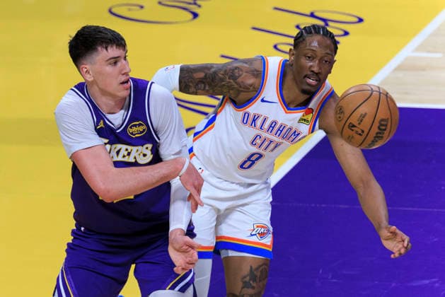 February 9, 2026, Los Angeles, California, USA: Jake LaRavia 12 of the Los Angeles Lakers keeps the ball in bounds as Jalen Williams 8 of the Oklahoma City Thunder attempts to intercept during their regular season NBA, Basketball Herren, USA game on Monday February 9, 2026 at Crypto.com Arena in Los Angeles, California. ARIANA RUIZ PI Lakers Vs. Thunder  - ZUMAp124 20260209_zaa_p124_006 Copyright: xArianaxRuizx