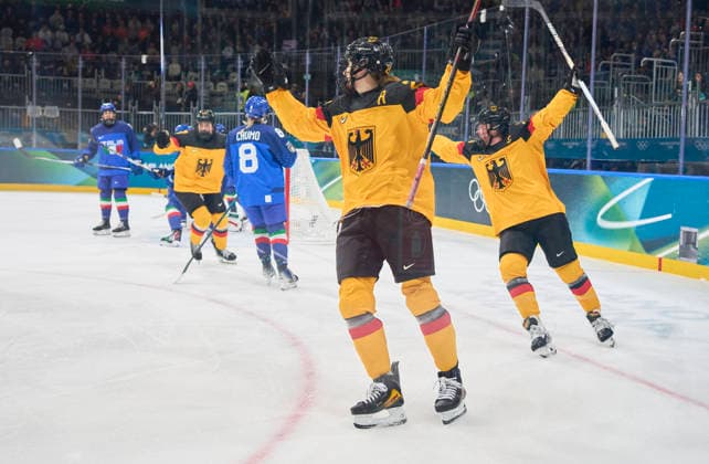 Emily Nix of Germany celebrates 1-1 goal, happy, laugh, celebration, with Laura Kluge of Germany Daria Gleissner of Germany at the preliminary women Ice hockey, Eishockey match Group B Germany - Italy of the Milano Cortina 2026 Winter Olympic Games, Olympische Spiele, Olympia, OS at Milano Rho Ice Hockey Arena on February 10, 2026 in Milan, Italy.